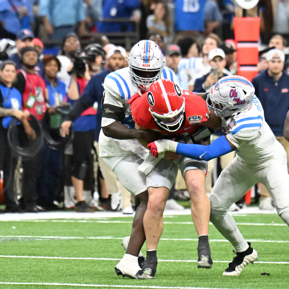 One former NFL scout said of Georgia quarterback Gunner Stockton (center), pictured being tackled against Ole Miss in the Sugar Bowl College Football Playoff game in January: "He’s a talented kid and a great leader, but we have to see if the traits equate to the NFL.” (Hyosub Shin/AJC)