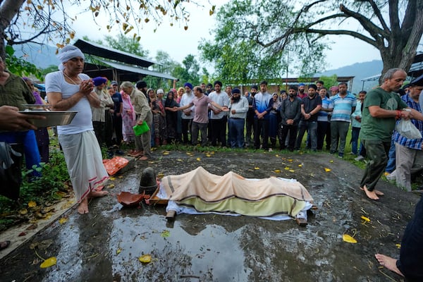 Sanjeev Barghava, left, performs the last rites of his son Vihaan Barghava, 30, killed in Pakistani artillery shelling in Poonch along the Line of Control, Indian controlled Kashmir, Thursday, May 8, 2025. (AP Photo/Channi Anand)