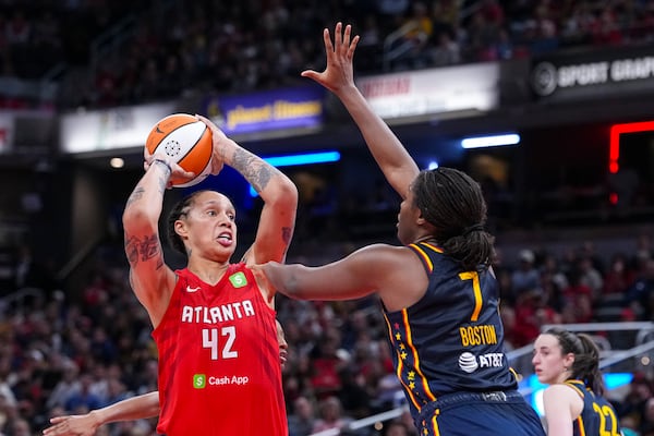 Atlanta Dream center Brittney Griner (42) shoots over Indiana Fever forward Aliyah Boston (7) in the second half of a WNBA basketball game in Indianapolis, Tuesday, May 20, 2025. (AP Photo/Michael Conroy)