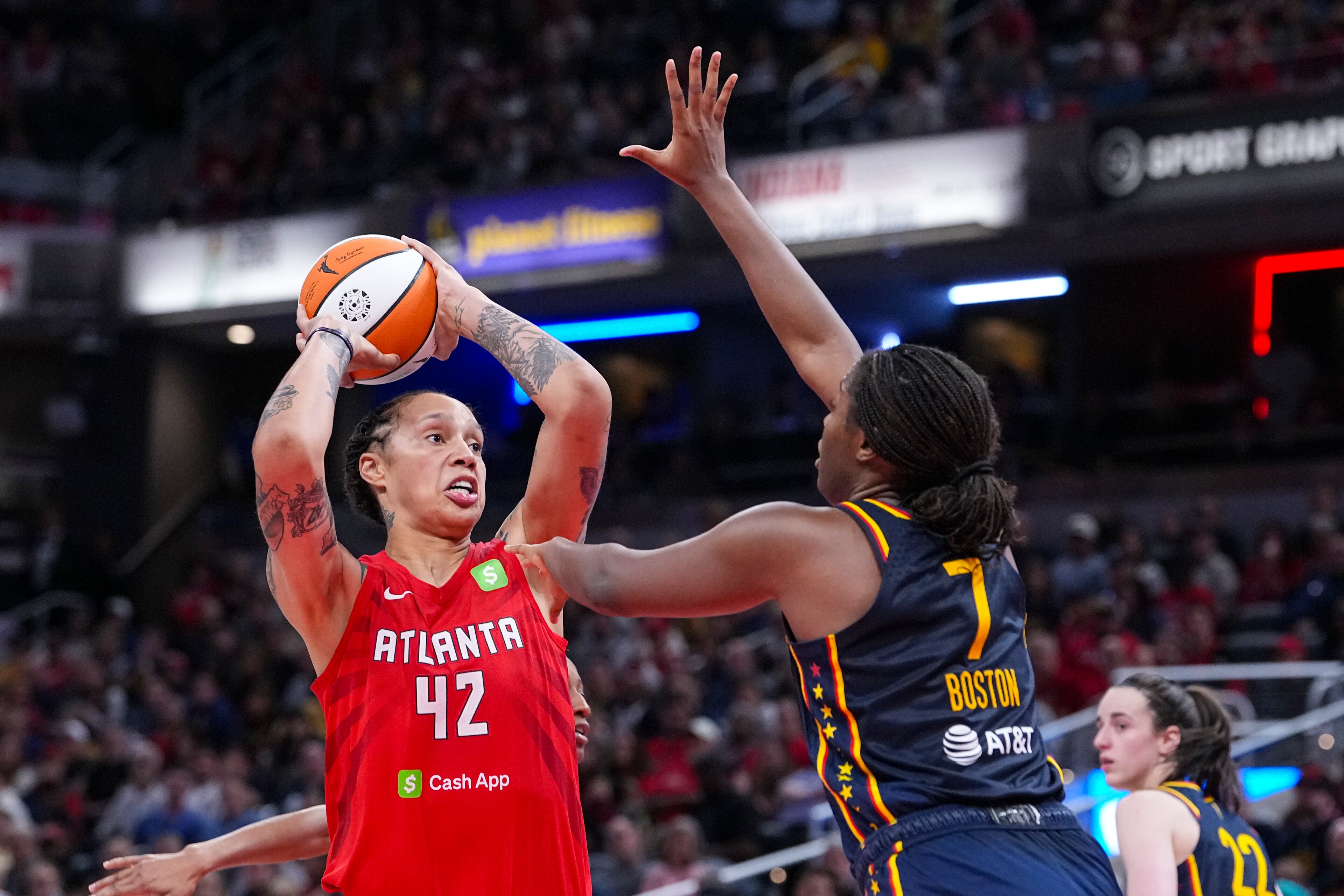 Atlanta Dream center Brittney Griner (42) shoots over Indiana Fever forward Aliyah Boston (7) in the second half of a WNBA basketball game in Indianapolis, Tuesday, May 20, 2025. (AP Photo/Michael Conroy)