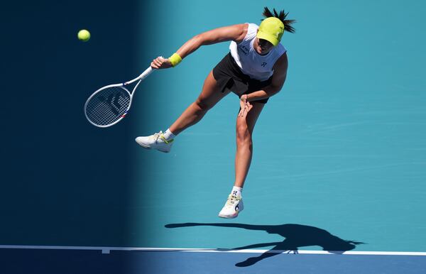 Iga Swiatek, of Poland, serves to Caroline Garcia, of France, during the Miami Open tennis tournament, Friday, March 21, 2025, in Miami Gardens, Fla. (AP Photo/Lynne Sladky)