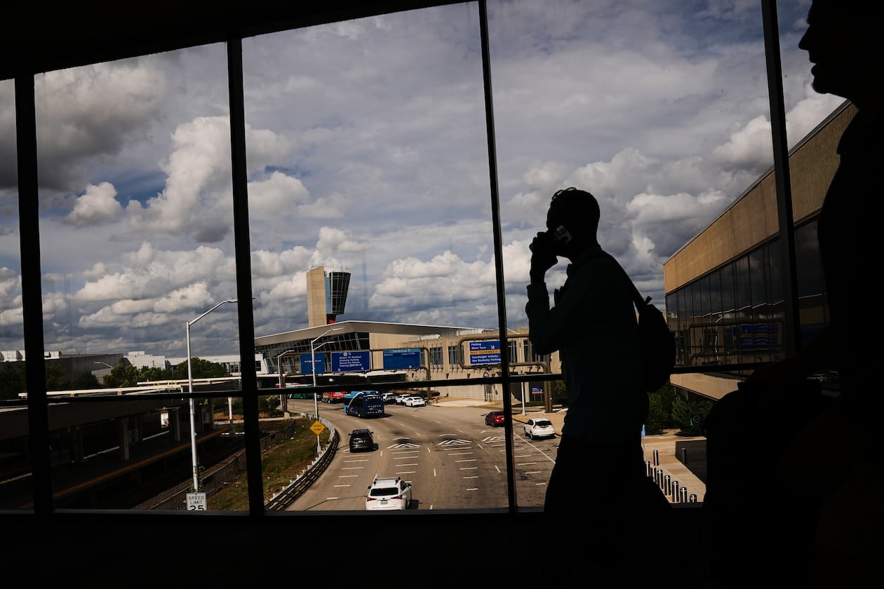 Passengers walk from a terminal at Philadelphia International Airport in Philadelphia, Tuesday, Oct. 7, 2025. (AP Photo/Matt Rourke)