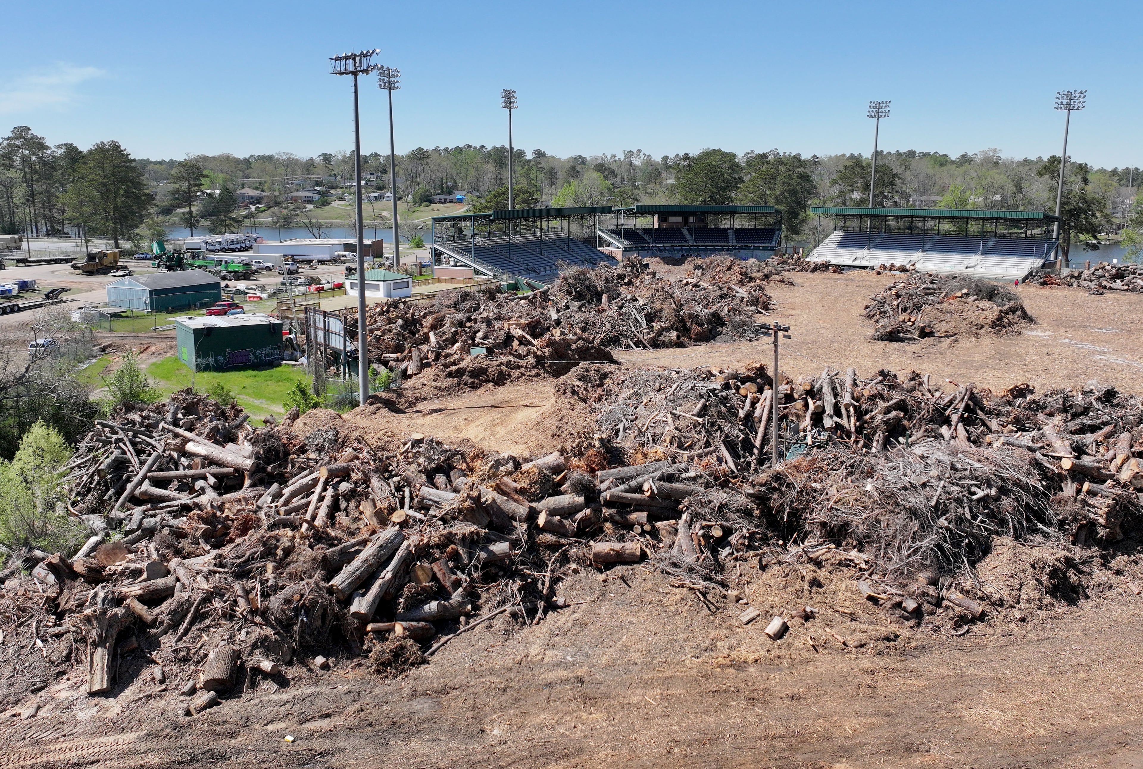 Aerial photo from March shows Augusta's Lake Olmstead Stadium, which was still being used as a cleanup site for downed trees six months after Hurricane Helene. (Hyosub Shin / AJC)