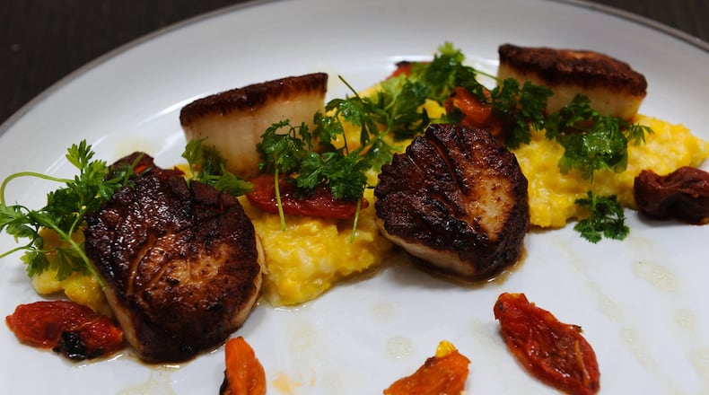 Seared Diver Scallops- Zellwood corn “grits”, Lemon Herbs salad at JP Atlanta. (BECKY STEIN PHOTOGRAPHY)