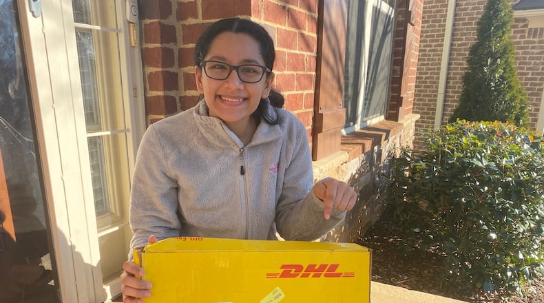 Alpharetta High School senior Davita Verma recently accepted 10 laptops on behalf of her nonprofit, Pencils for Success, from the DHL Helping Learners program. (Courtesy DHL and Davita Verma)