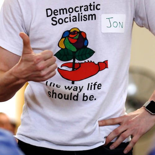 FILE - Jon Torsch wears a t-shirt promoting democratic socialism during a gathering of the Southern Maine Democratic Socialists of America at City Hall in Portland, Maine, July 16, 2018. (AP Photo/Charles Krupa)