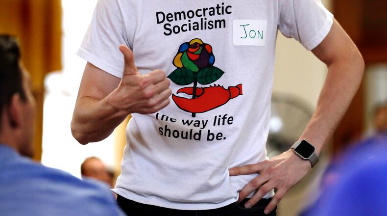 FILE - Jon Torsch wears a t-shirt promoting democratic socialism during a gathering of the Southern Maine Democratic Socialists of America at City Hall in Portland, Maine, July 16, 2018. (AP Photo/Charles Krupa)