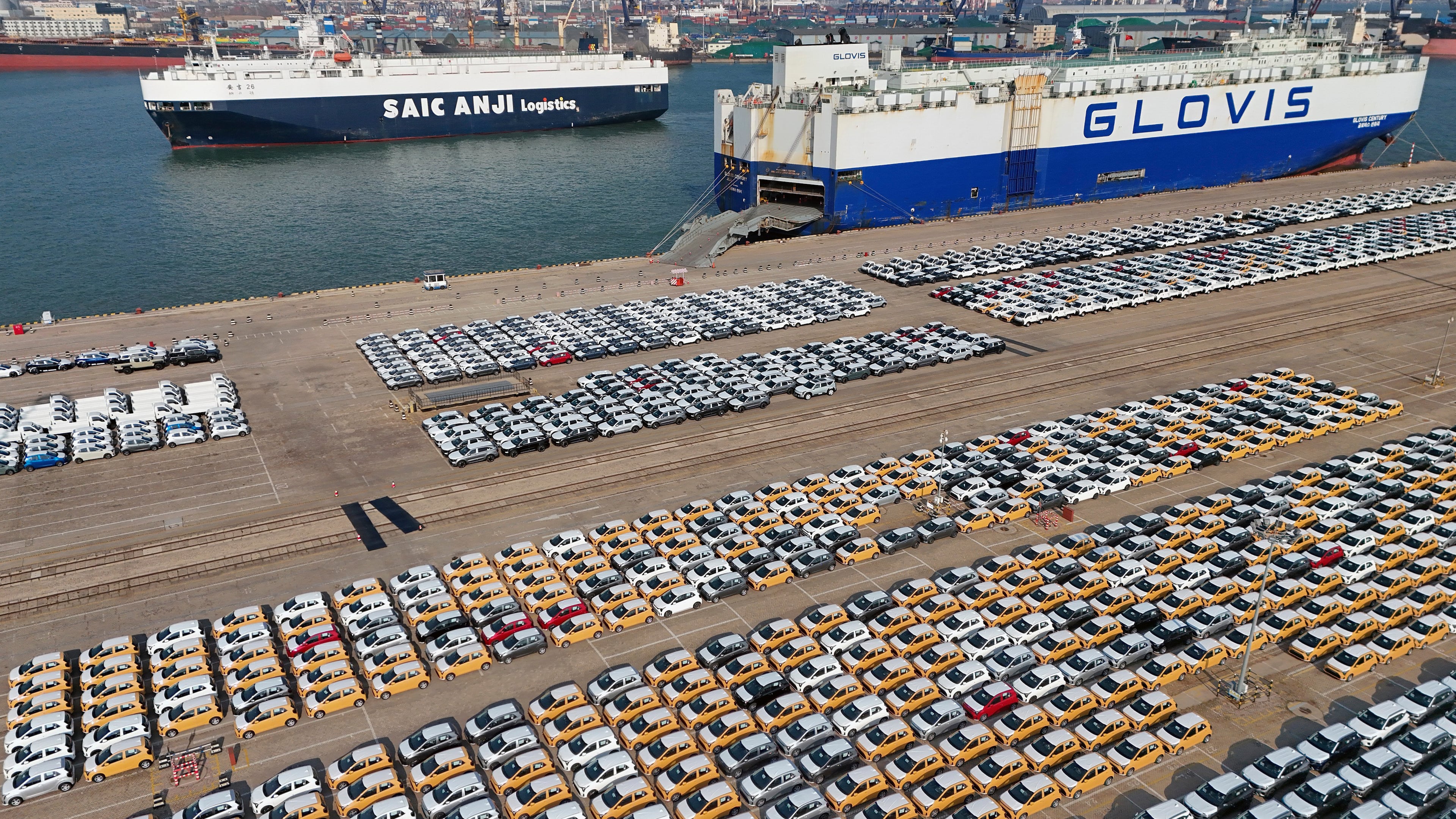 FILE - Vehicles and trucks for export wait for transportation from a port in Yantai in eastern China's Shandong province on Jan. 2, 2025. (Chinatopix via AP, File)