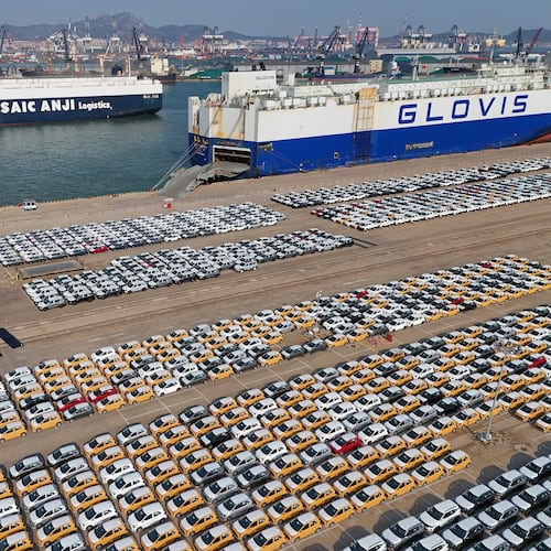FILE - Vehicles and trucks for export wait for transportation from a port in Yantai in eastern China's Shandong province on Jan. 2, 2025. (Chinatopix via AP, File)