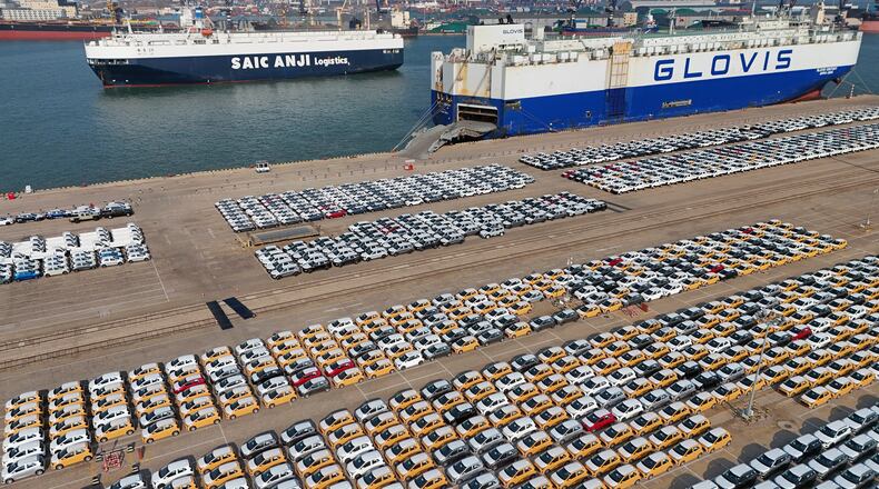 FILE - Vehicles and trucks for export wait for transportation from a port in Yantai in eastern China's Shandong province on Jan. 2, 2025. (Chinatopix via AP, File)
