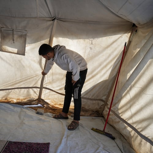 Muhannad Abu Muharib, 27, reinforces his tent after it was damaged by the storm at a temporary camp on the beach in Deir al-Balah, in the central Gaza Strip, Saturday, Nov. 15, 2025.(AP Photo/Abdel Kareem Hana)