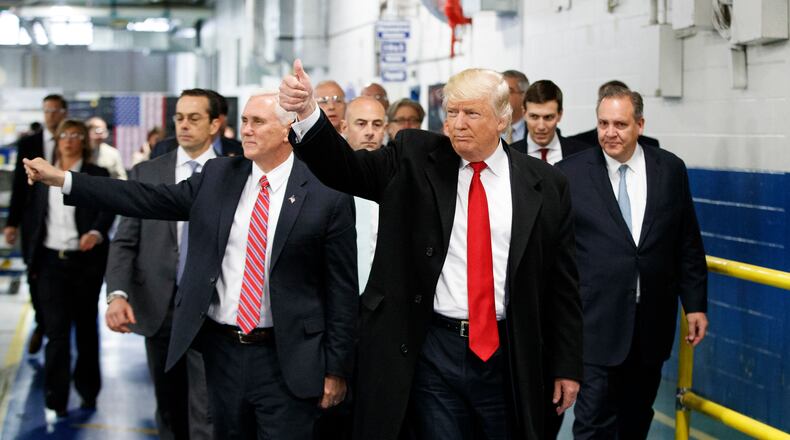 President-elect Donald Trump and Vice President-elect Mike Pence wave as they visit to Carrier factory, Thursday, Dec. 1, 2016, in Indianapolis, Ind. (AP Photo/Evan Vucci)