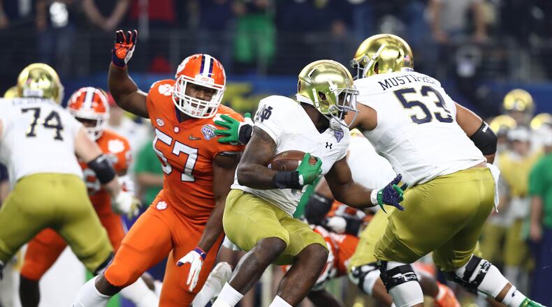 Dec 29, 2018; Arlington, TX, United States; Notre Dame Fighting Irish running back Dexter Williams (2) runs with the ball past Clemson Tigers linebacker Tre Lamar (57) in the 2018 Cotton Bowl college football playoff semifinal game at AT&T Stadium. Mandatory Credit: Matthew Emmons-USA TODAY Sports
