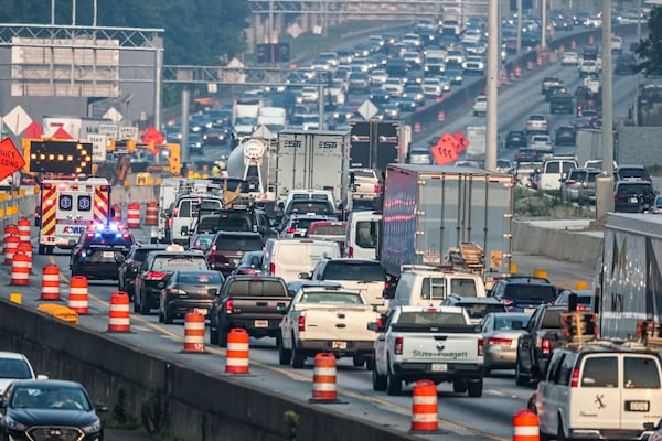 A tractor-trailer driver is facing multiple charges, including DUI, after crashing into a car on I-285 and injuring two people Tuesday morning, July 18, 2023 in Sandy Springs, police said. (John Spink/AJC)

