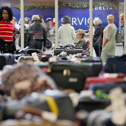 In this December 2017 photo, passengers feel the effects of a massive power outage at Hartsfield-Jackson Atlanta International Airport as they endure long lines to claim baggage and ride shuttles. (Bob Andres/AJC)