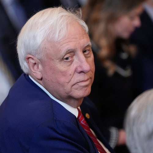 FILE - Sen. Jim Justice, R-W.Va., listens as President Donald Trump speaks during an event on energy production in the East Room of the White House, April 8, 2025, in Washington. (AP Photo/Alex Brandon, File)