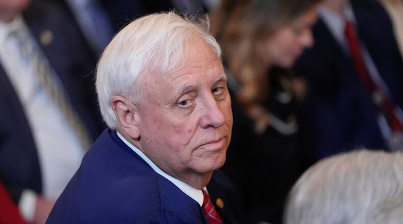 FILE - Sen. Jim Justice, R-W.Va., listens as President Donald Trump speaks during an event on energy production in the East Room of the White House, April 8, 2025, in Washington. (AP Photo/Alex Brandon, File)