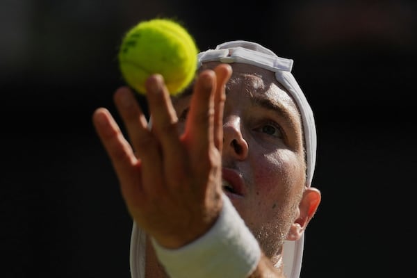 Jan-Lennard Struff of Germany serves to Carlos Alcaraz of Spain during a third round men's singles match at the Wimbledon Tennis Championships in London, Friday, July 4, 2025. (AP Photo/Kin Cheung)