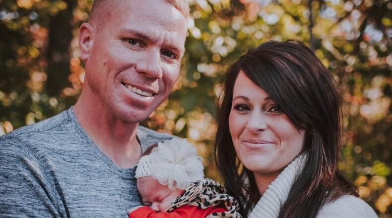 This is a photo of Drue and Kristen Green holding their infant , Emersyn Rose, that was posted on the GoFundMe page for his medical expenses.