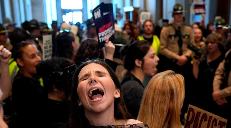 A woman protests outside the House chamber before a special session of the state legislature to redraw U.S. Congressional voting maps Thursday, May 7, 2026, in Nashville, Tenn. (AP Photo/George Walker IV)