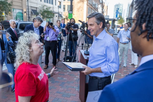Derek Dooley (with binder) is a Republican candidate for the U.S. Senate. (Arvin Temkar/AJC)