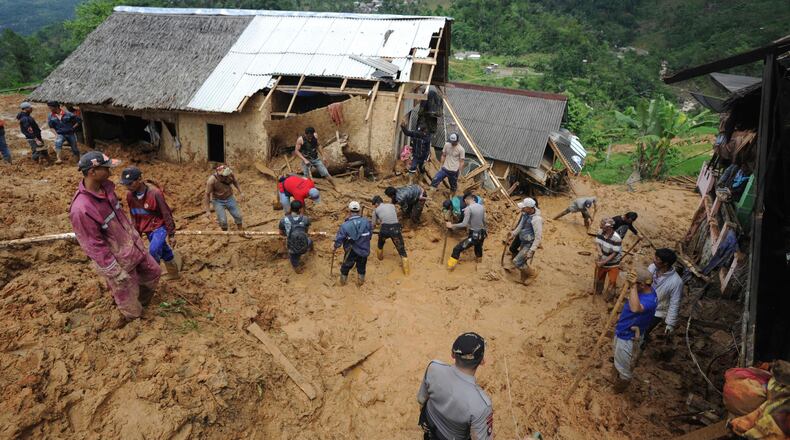 Rescuers search for victims at a village hit by a landslide in Sirnaresmi, West Java on Tuesday.