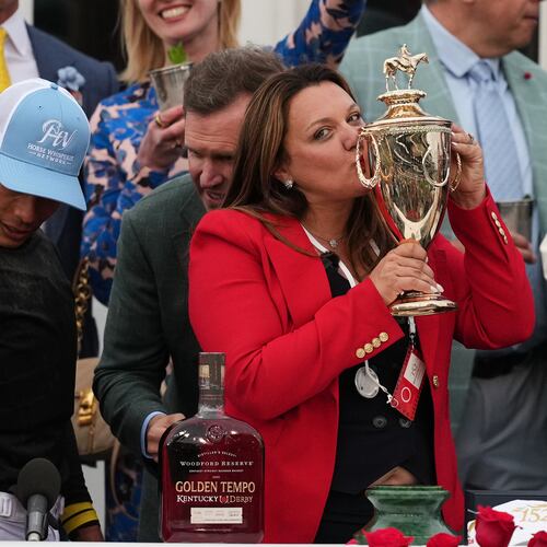 Trainer Cherie DeVaux kisses the trophy after a victory by Golden Tempo in the 152nd running of the Kentucky Derby horse race at Churchill Downs, Saturday, May 2, 2026, in Louisville, Ky. (AP Photo/Abbie Parr)