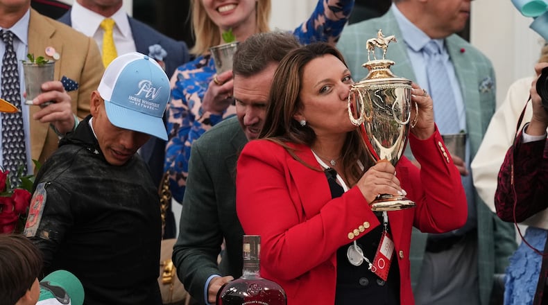 Trainer Cherie DeVaux kisses the trophy after a victory by Golden Tempo in the 152nd running of the Kentucky Derby horse race at Churchill Downs, Saturday, May 2, 2026, in Louisville, Ky. (AP Photo/Abbie Parr)