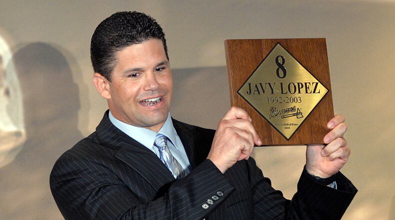 Former Braves catcher Javy Lopez shows his plaque during the Braves Hall of Fame luncheon Friday. Lopez, former head athletic trainer Dave Pursley, and former Boston Braves shortstop Rabbit Maranville are being inducted.