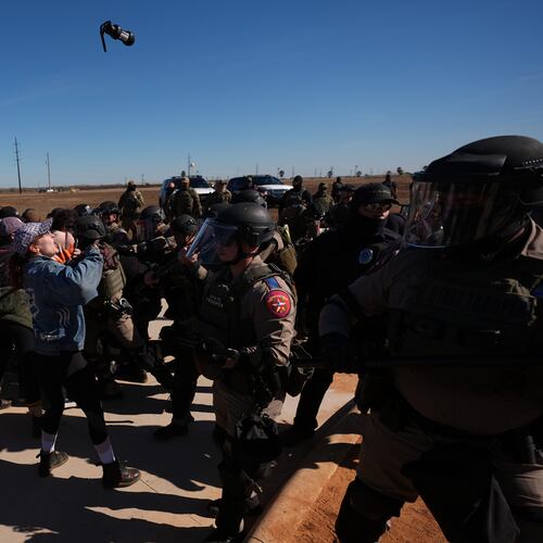A canister of pepper spray launched by Texas troopers flies towards protesters outside the South Texas Family Residential Center detention facility where Liam Ramos and his father are being detained in Dilley, Texas, Wednesday, Jan. 28, 2026. (AP Photo/Eric Gay)