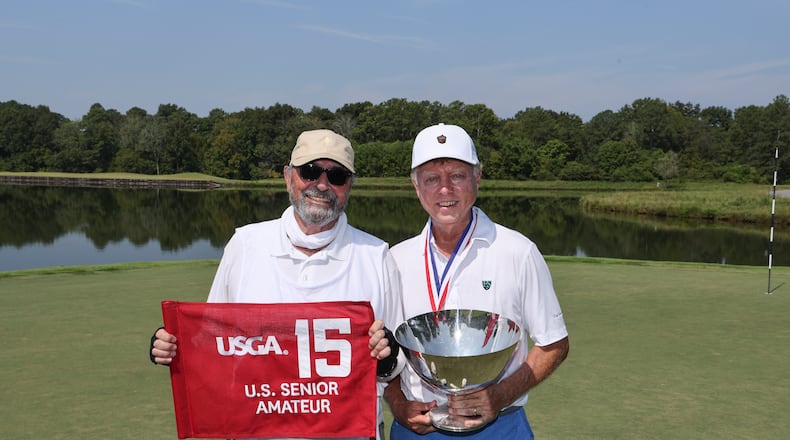 Louis Brown holds the Frederick L. Dold Championship Trophy alongside caddie Hawk Nucara after winning the final match 4 and 3 at the 2024 U.S. Senior Amateur at The Honors Course in Ooltewah, Tenn. on Thursday, Aug. 29, 2024. (Jeff Haynes/USGA)