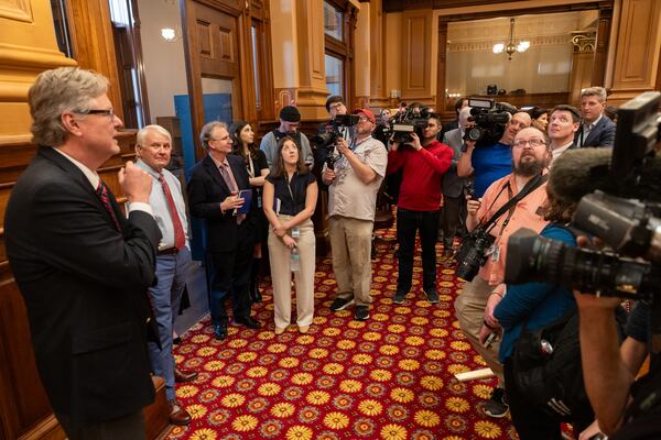 Gerald Pilgrim (front left) told reporters about the restoration process at the House of Representatives in Atlanta last Wednesday. (Arvin Temkar/AJC
