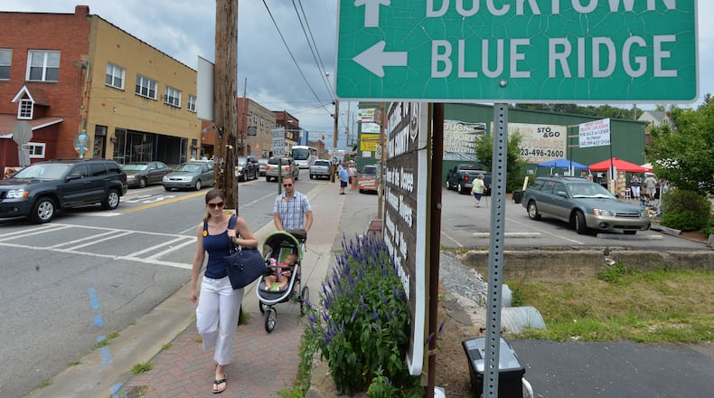 Tourists walk by on Toccoa Avenue in McCaysville, Georgia. McCaysville is along the border between North Georgia and southeast Tennessee, along with its twin city of Copperhill, Tennessee.