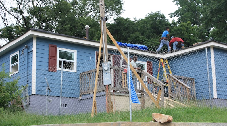 Workers repair a home in Atlanta’s Pittsburgh neighborhood that was ravaged by mortgage foreclosures during the Great Recession. Photo: Russell Grantham/AJC staff.