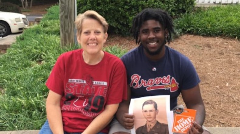 Grady High School principal Betsy Bockman is shown with 2019 graduate Dale Turnipseed, who is holding a photo of 1946 Tech High graduate Jim Logan. To honor Logan on his 91st birthday, his family wanted to give a donation to a current APS student. Bockman recommended Turnipseed.