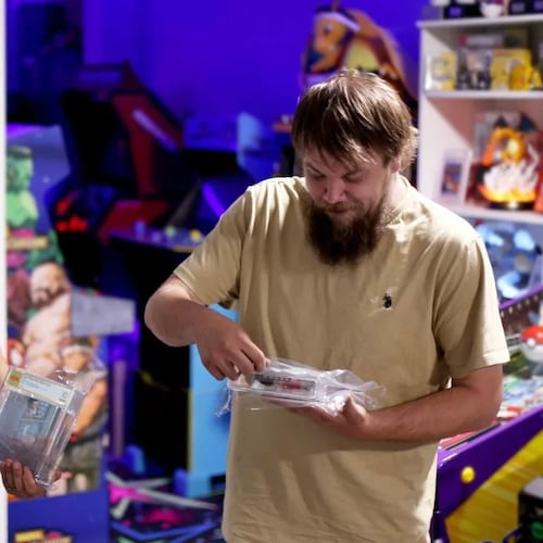 In this photo provided by Nintendo Wire, publisher Jason Ganos, left, and OneStopWonders store owner Kevin Braun hold PSA graded copies of Super Mario Bros. and Duck Hunt video games on Wednesday, June 17, 2026, which they rediscovered in a warehouse in Waukesha, Wis. (Lauren Ganos/Nintendo Wire via AP)