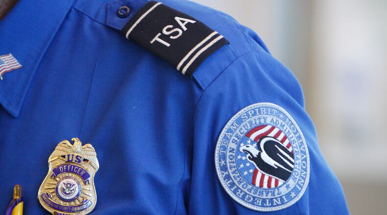 FILE -The badge and TSA logo patch are seen on the uniform of a Transportation Security Administration employee at one of the security checkpoints inside Lambert- St. Louis International Airport Oct. 7, 2010, in St. Louis. (AP Photo/Jeff Roberson, File)