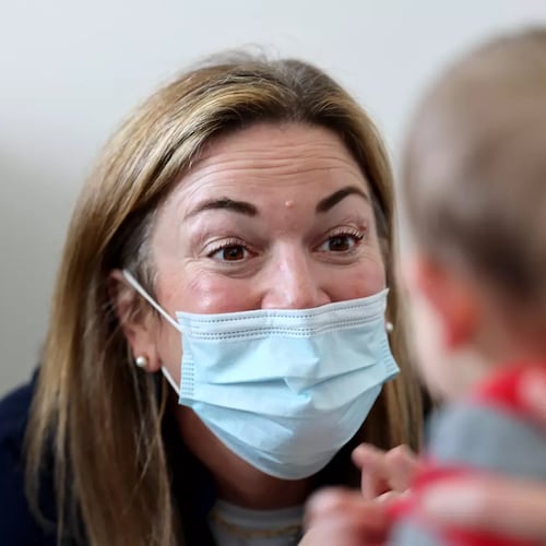 Dr. Neville Anderson (left) interacts with Arlo Vasquez held by his mom Christa Iacono (not pictured) while getting flu, Covid and Hepatitis B vaccinations at Larchmont Pediatrics in Los Angeles. (Allen J. Schaben/Los Angeles Times/TNS)
