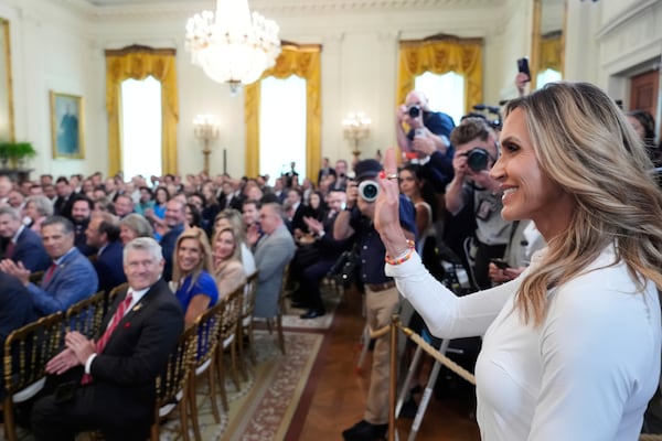 Lara Trump waves to the audience as President Donald Trump speaks at an event for the signing of the GENIUS Act, a bill that regulates stablecoins, a type of cryptocurrency, in the East Room of the White House, Friday, July 18, 2025, in Washington. (AP Photo/Alex Brandon)