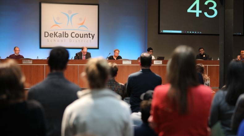 A crowd gathers before the public meeting of the DeKalb County Board of Education meeting at the DeKalb County School District headquarters in Stone Mountain. (Miguel Martinez/For the AJC)