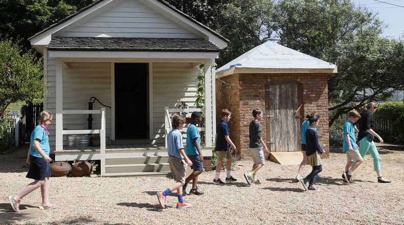 May 2, 2019 - Marietta - West Side Elementary School students from Marietta tour the Root House. The kitchen (left) was reconstructed in the 90’s from the same old insurance records that are currently being used to reconstruct the smokehouse (right). Cobb Landmarks is renovating its William Root House Museum, an old house in downtown Marietta that showcases the lives of people in antebellum Georgia. They have began reconstructing the smokehouse and a log cabin on to the site. Bob Andres / bandres@ajc.com