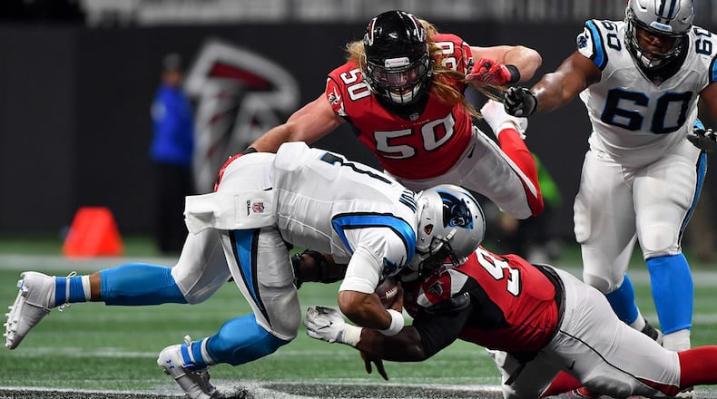 Falcons defensive end Brooks Reed (50) flies to the aid of defensive tackle Grady Jarrett (97) as Carolina Panthers quarterback Cam Newton (1) is brought down during the first half Sunday December 31, 2017. Photo by Brant Sanderlin/AJC file