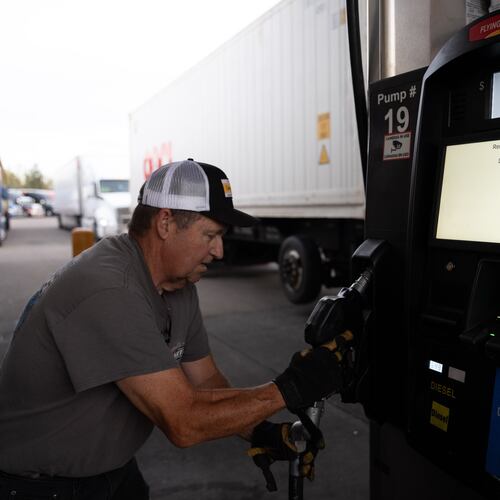 Chuck Byrd puts away a fuel nozzel after filling two tanks for a truck at a gas station on Tuesday, April 7, 2026, in Aurora, Ore. (AP Photo/Jenny Kane)