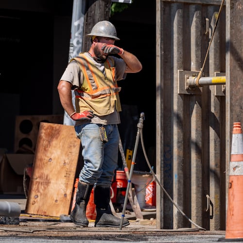 A Line Vac employee wipes the sweat from his forehead on Decatur Street on Tuesday, July 29, 2025, as temperatures in Atlanta hit 100 degrees. A heat advisory remains in effect for Wednesday, and the high temperature is predicted to reach 92 degrees. (Ben Hendren for the AJC)