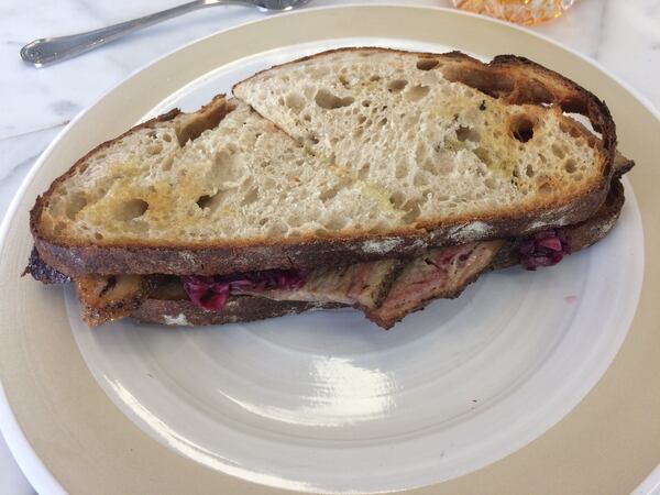 Mourning Dove Cafe chef Andrea Kirshtein smokes brisket on a Big Green Egg for sandwiches such as the one pictured here. CONTRIBUTED BY WENDELL BROCK