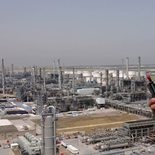 FILE - A Kuwaiti oil worker talks on his radio at Mina Abdulah Oil Refinery, 50 Km South of Kuwait City in this file photo taken April 2005. (AP Photo/Gustavo Ferrari, File)