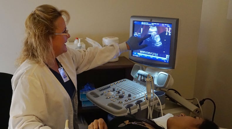 Perin Stowers (left) performs an ultrasound on patient Yenni Ortiz at the Hall County Health Department in Gainesville. (Photo by Phil Skinner)