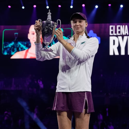 Elena Rybakina of Kazakhstan poses with the trophy after defeating Aryna Sabalenka of Belarus in the women's final singles match of the WTA finals in Riyadh, Saudi Arabia, Saturday, Nov. 8, 2025. (AP Photo/ Fatima Shbair)