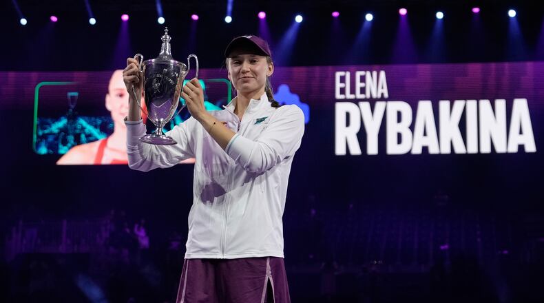 Elena Rybakina of Kazakhstan poses with the trophy after defeating Aryna Sabalenka of Belarus in the women's final singles match of the WTA finals in Riyadh, Saudi Arabia, Saturday, Nov. 8, 2025. (AP Photo/ Fatima Shbair)