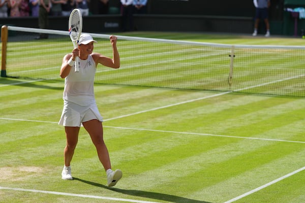Iga Swiatek of Poland celebrates winning the women's singles final match against Amanda Anisimova of the U.S. at the Wimbledon Tennis Championships in London, Saturday, July 12, 2025.(AP Photo/Kirsty Wigglesworth)